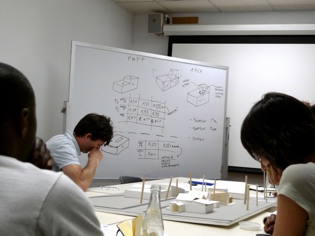 The image here shows a group of students very intently working together on passive house standards of our house.