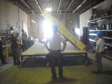 eric is standing (foreground) as panel is lifted by hook vertically