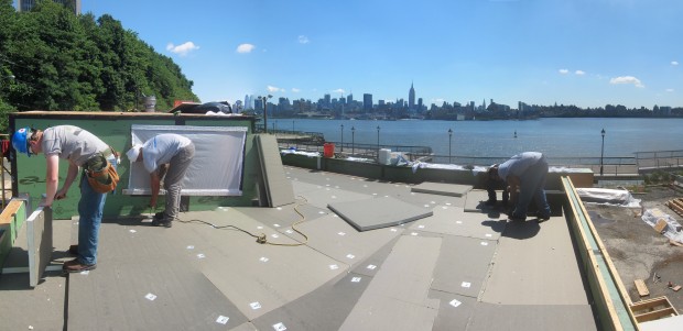 polyiso boards being installed on the roof