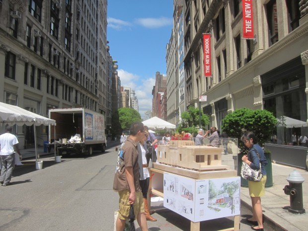 looking down 13th street at the parsons street festival with empowerhouse model in foreground